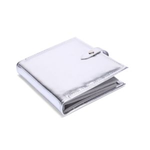 ALT A closed metallic silver PU leather earring holder book with a smooth foil finish and a snap button strap closure on the side.