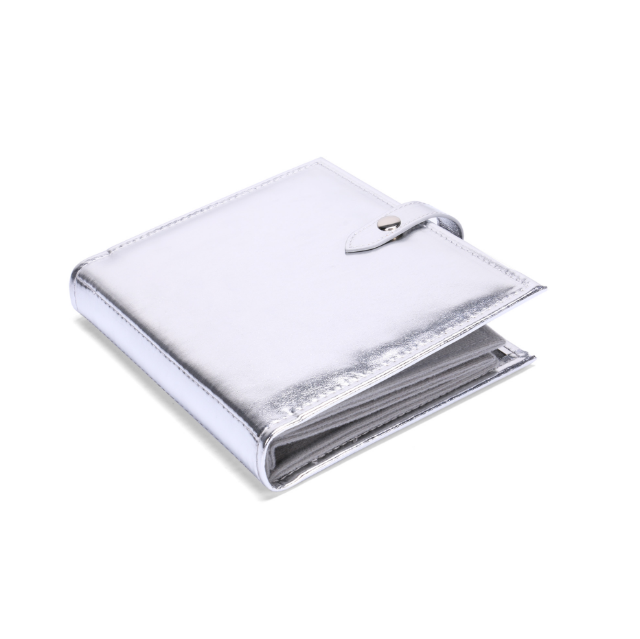 ALT A closed metallic silver PU leather earring holder book with a smooth foil finish and a snap button strap closure on the side.
