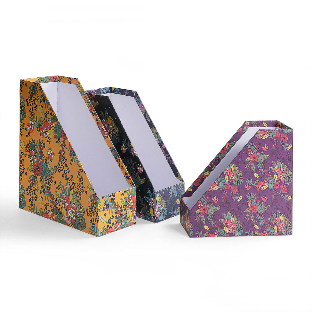 ALT Three tropical print cardboard file racks shown from the side, displaying the slanted opening designed for easy access to magazines and documents