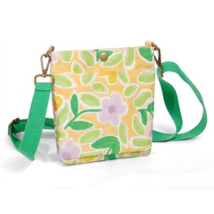 ALT A cotton canvas crossbody bag with a bright floral print, a bronze snap closure on the front flap, a green adjustable webbing strap, and bronze swivel snap hooks