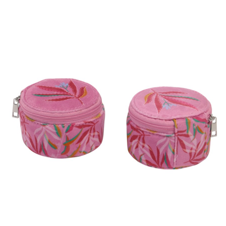 ALT Two pink round velvet jewelry cases side by side, showing the embroidered leaf motif on the lids and the coordinating printed leaf pattern on the sides, with silver zipper pulls