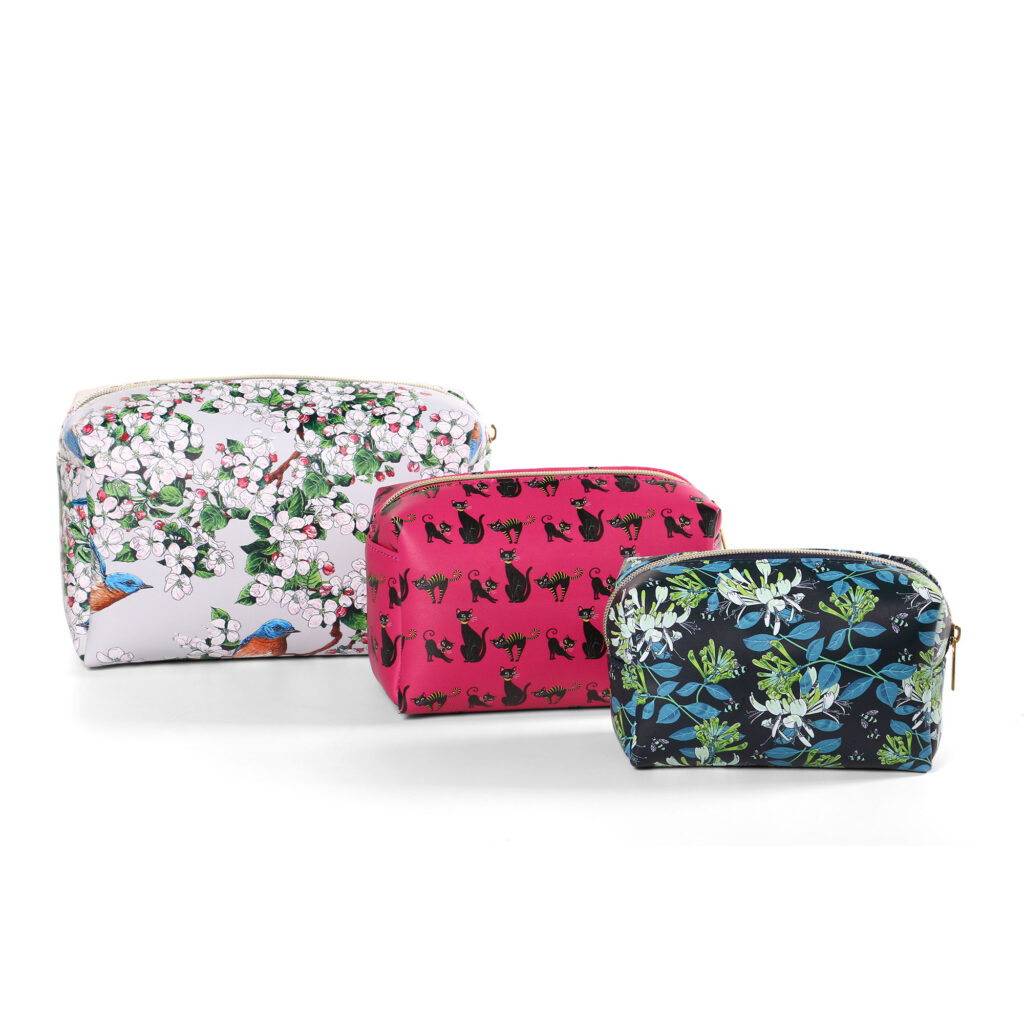 assorted print cosmetic bags set with white bird floral, pink black cat, and navy blue floral patterns